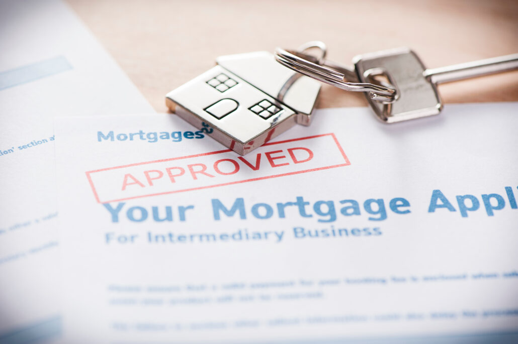 Mortgage loan application with a lock and key placed on top of it.