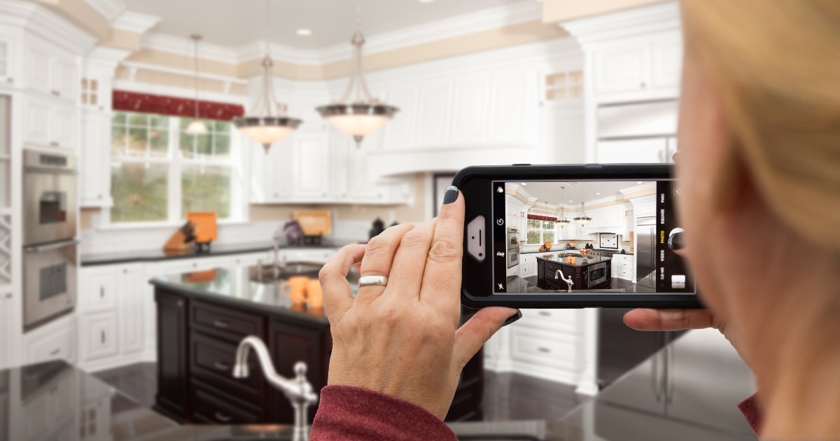 Homeowner taking a photo of their kitchen to showcase on social media.