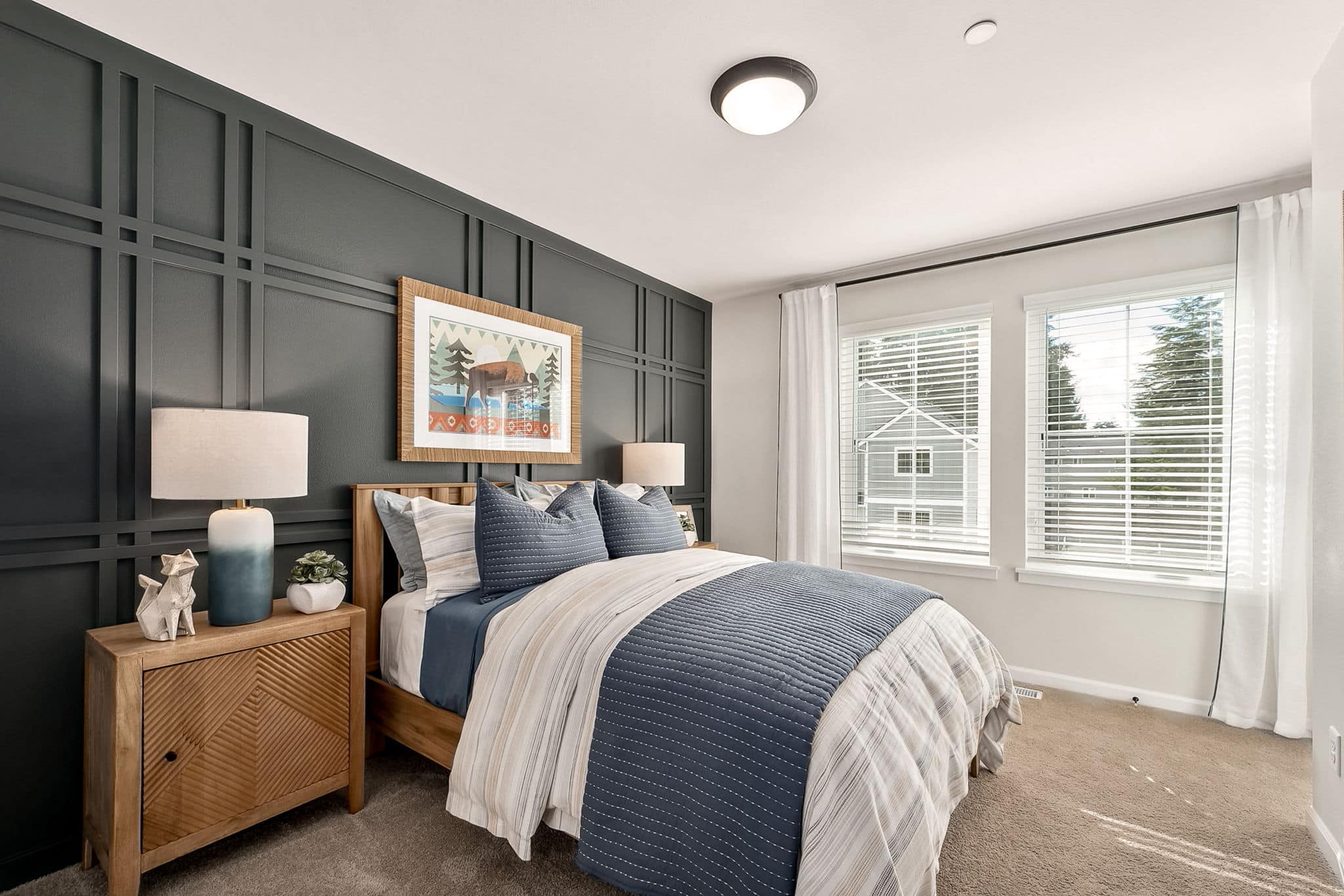 Second bedroom with overhead lighting, large windows and carpeting in the Noble at Shaw Heights.