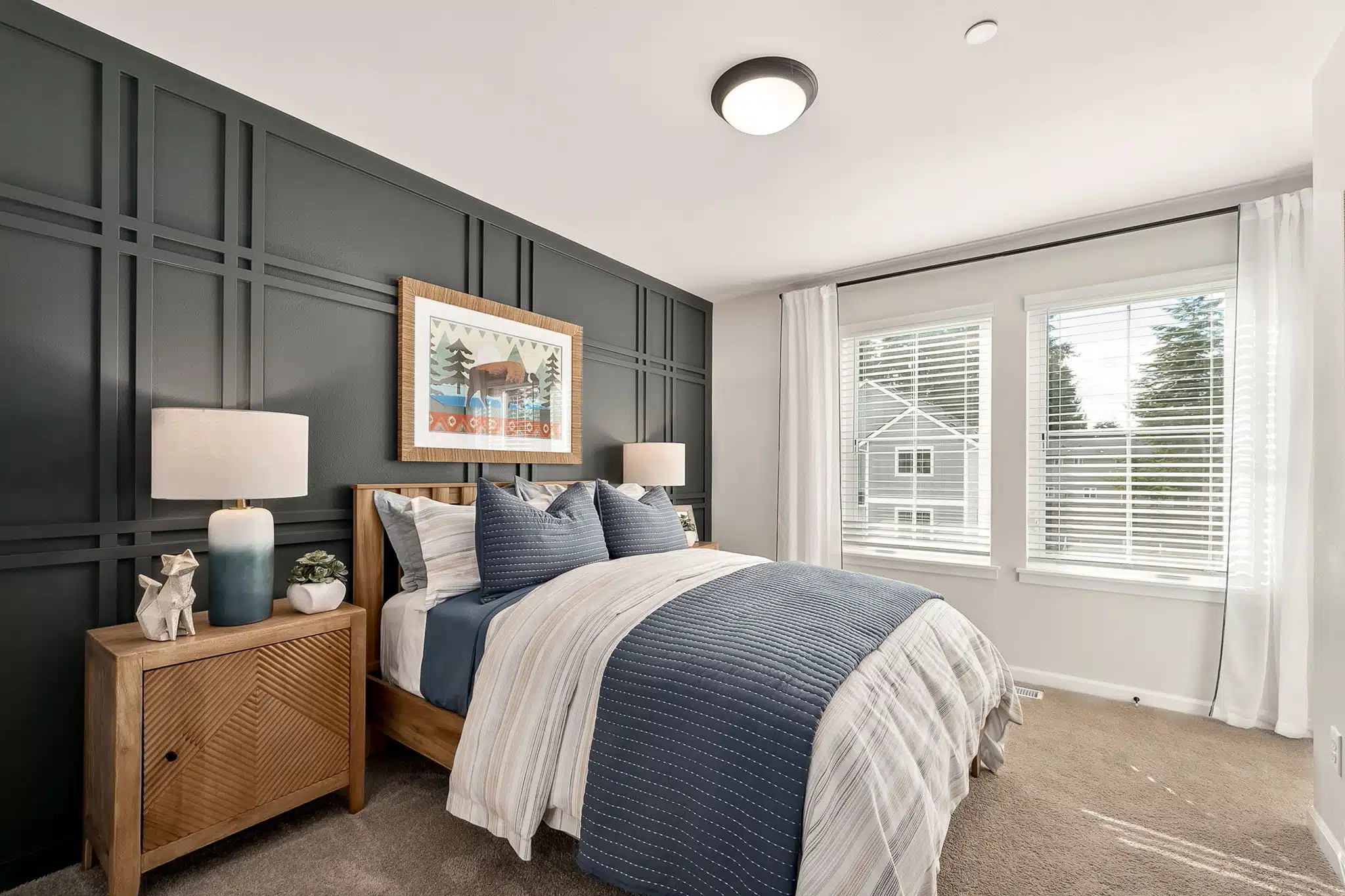 Second bedroom with overhead lighting, large windows and carpeting in the Noble at Shaw Heights.