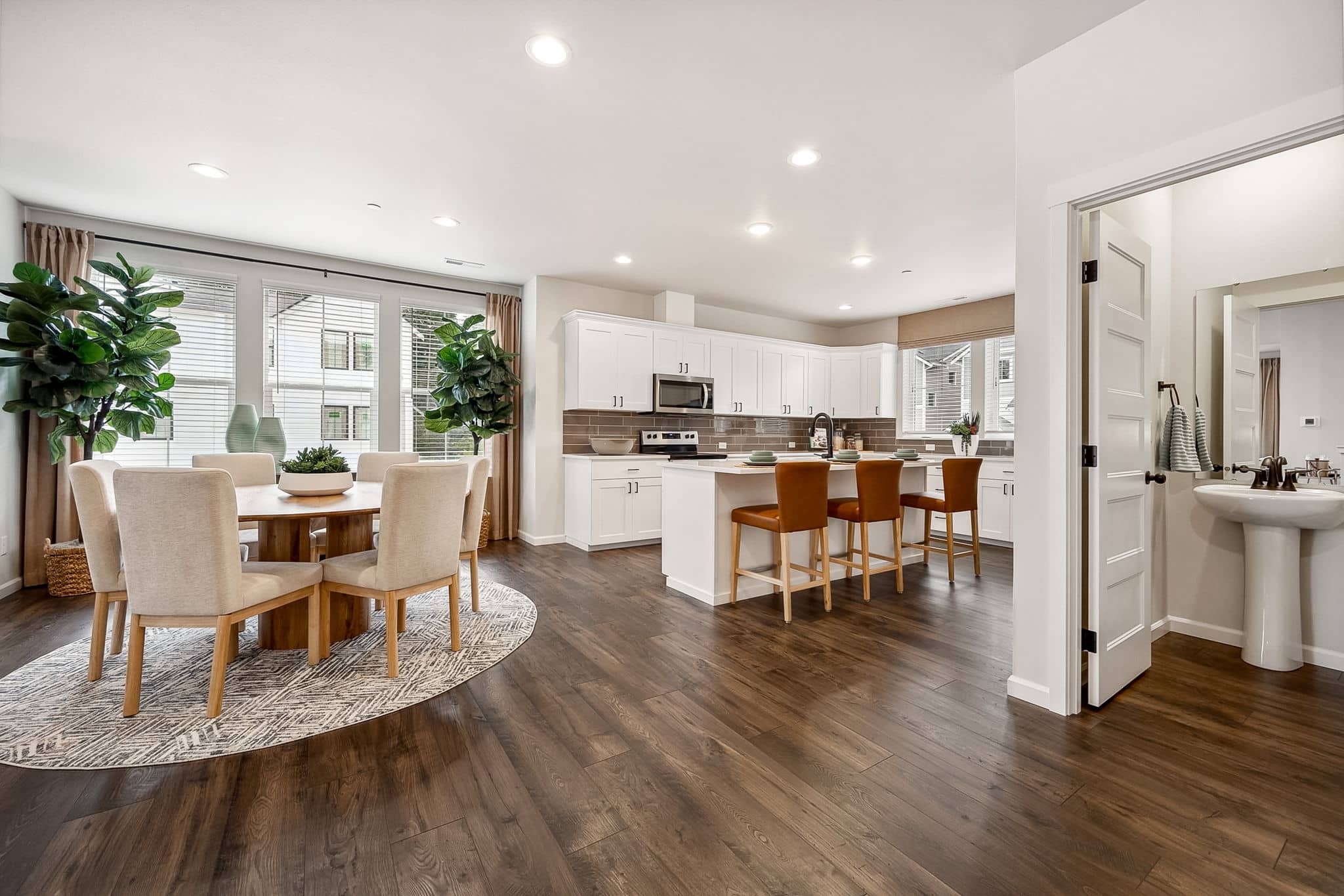 Litchen, island and dining are in the Noble with white cabinetry and stainless steel appliances.