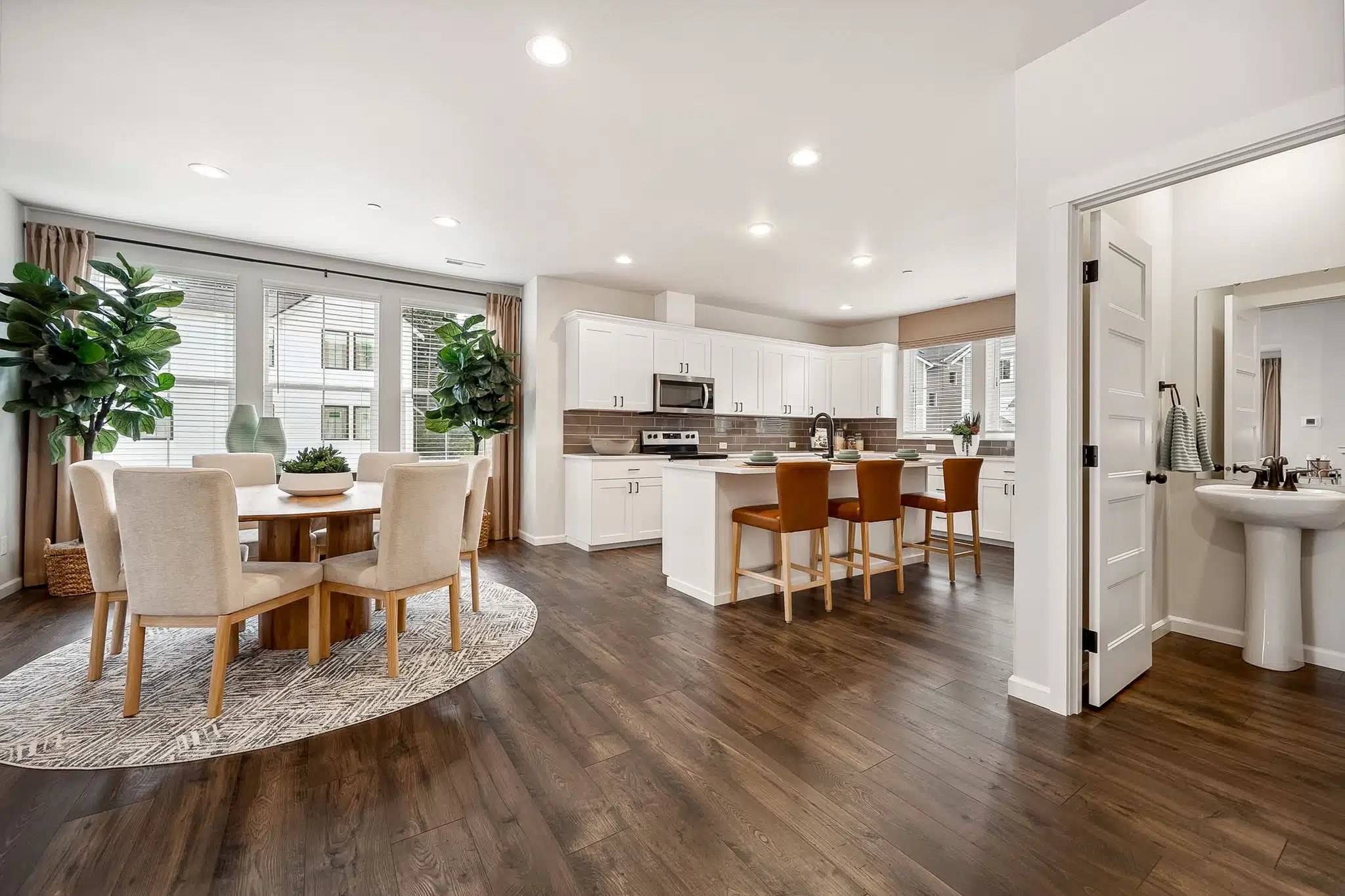 Litchen, island and dining are in the Noble with white cabinetry and stainless steel appliances.