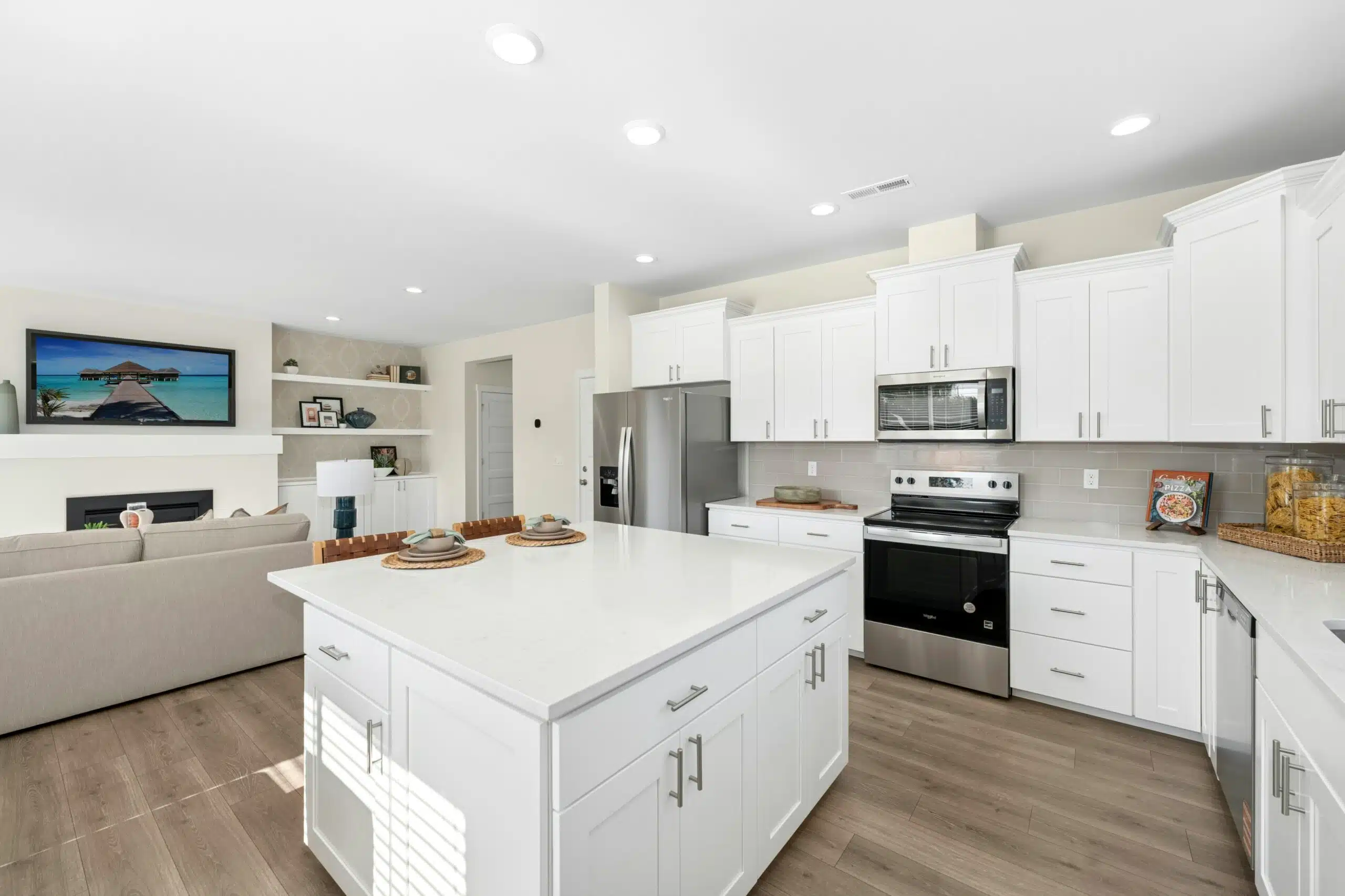 Kitchen with white cabinets, stainless steel appliances and light countertops