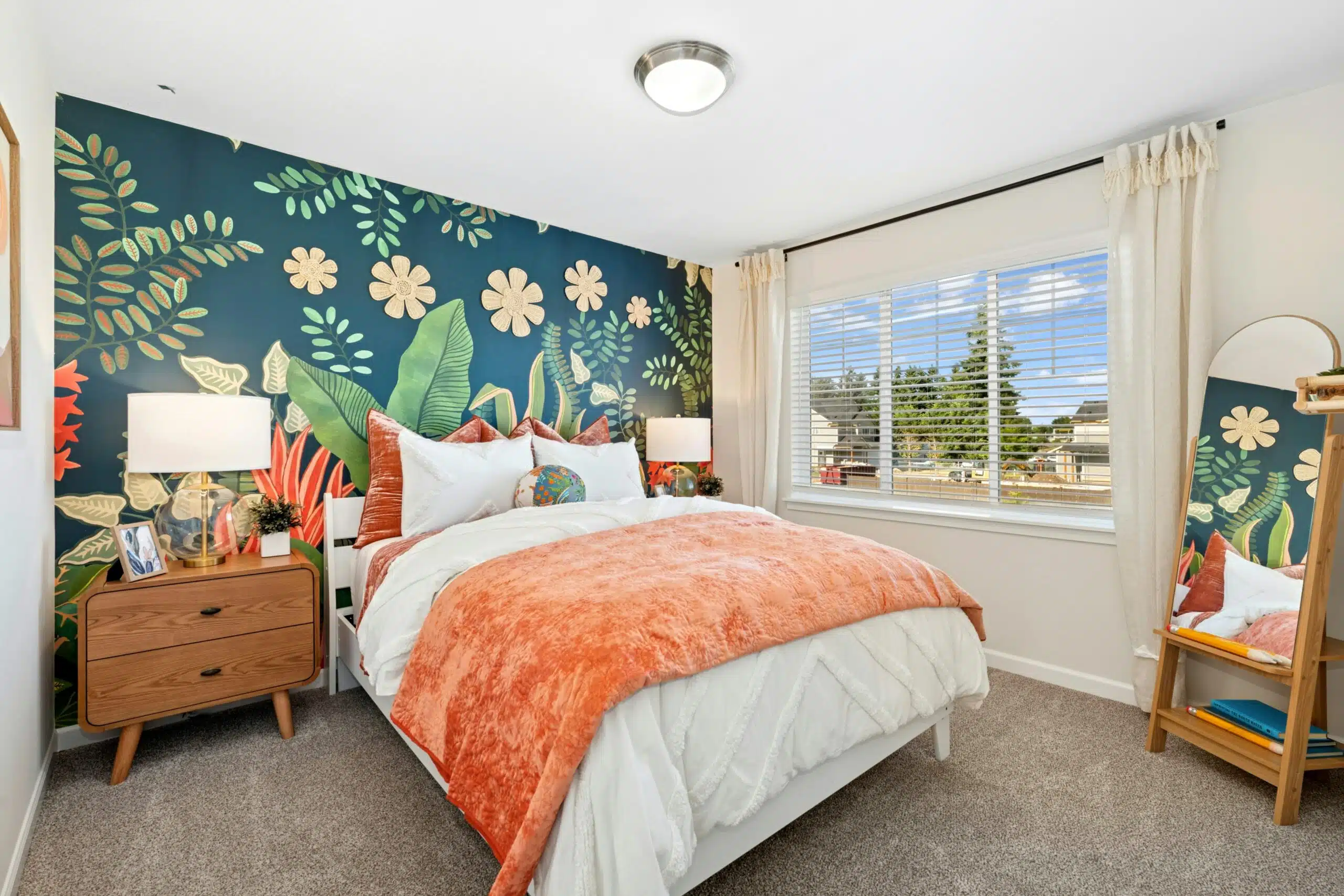 Secondary bedroom with carpet, curtains and overhead lighting.